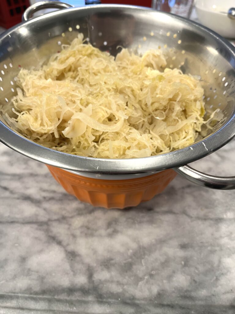 draining Sauerkraut for Polish Sauerkraut Soup aka Kapusniak