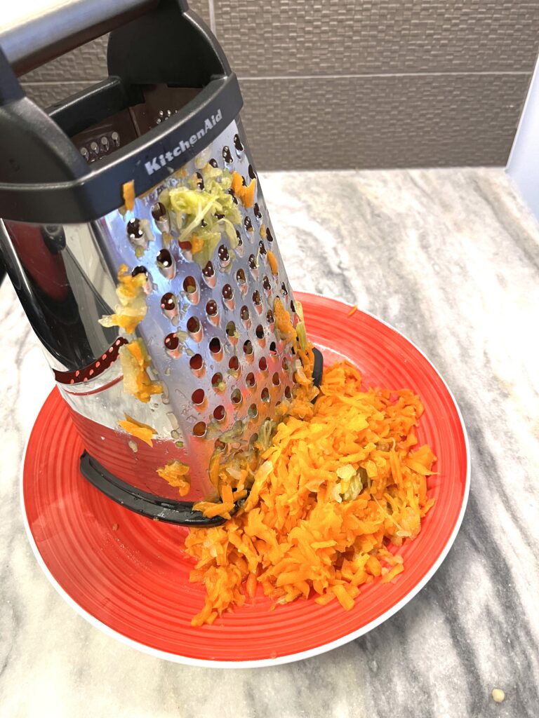 grating carrots for Red borscht aka Barszcz czerwony