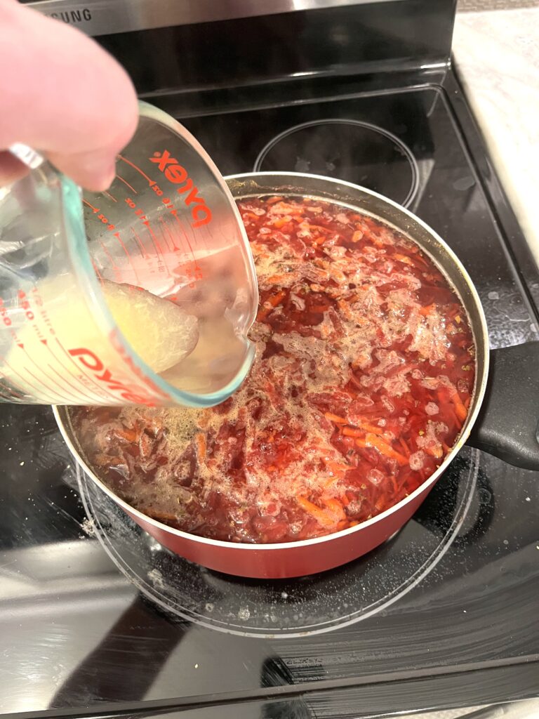 adding lemon juice to Red borscht aka Barszcz czerwony