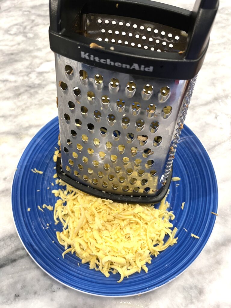 grating dough for Polish apple pie aka Szarlotka